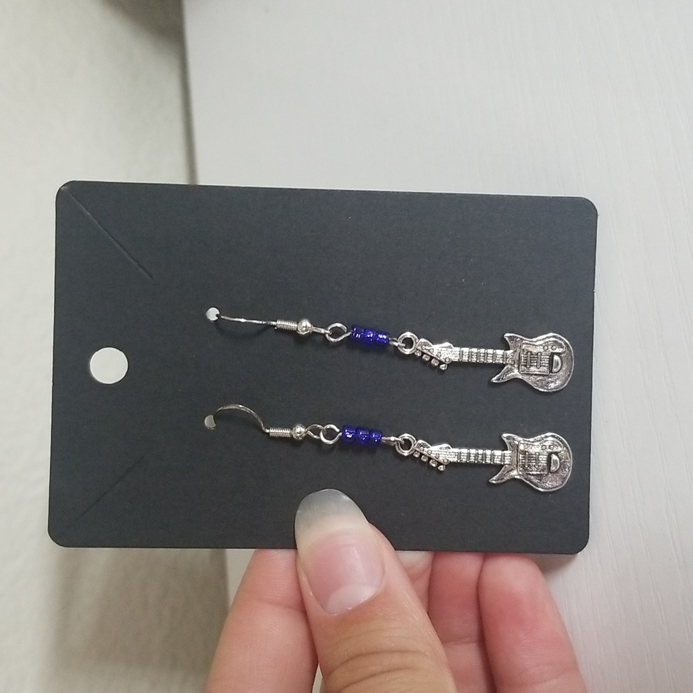Handmade earrings with guitar charms.